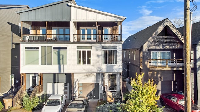 view of front of house with central AC and a balcony