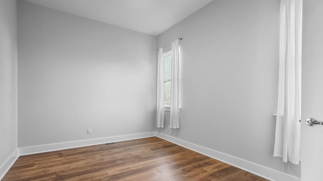 spare room featuring dark hardwood / wood-style floors