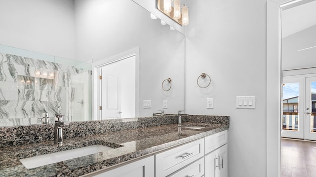 bathroom featuring a shower, wood-type flooring, vanity, and french doors