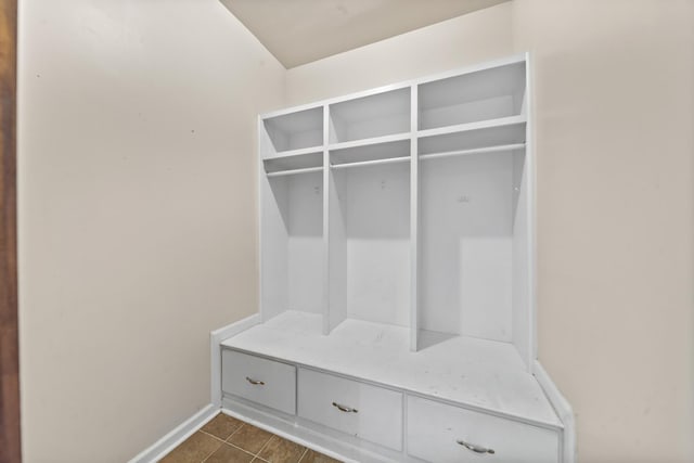 mudroom featuring dark tile patterned flooring