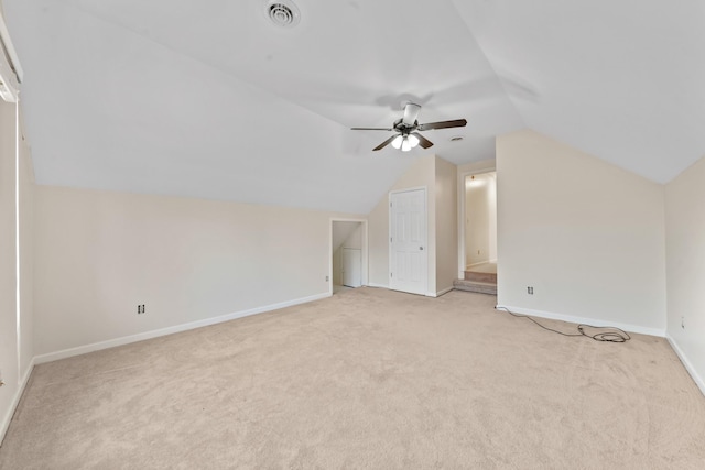 additional living space with lofted ceiling, light carpet, and ceiling fan