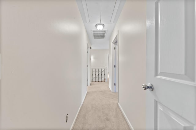 hall with light colored carpet