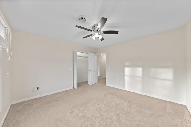 unfurnished bedroom featuring ceiling fan, a closet, and light carpet