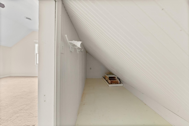 additional living space featuring lofted ceiling and carpet