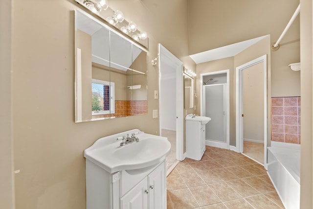 bathroom featuring tile patterned flooring, vanity, and plus walk in shower