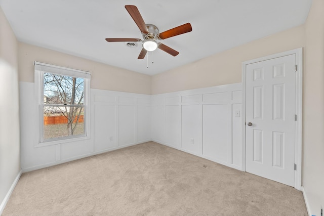 empty room featuring light carpet and ceiling fan