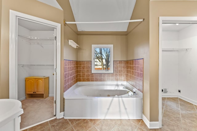 bathroom featuring a bath and tile patterned flooring