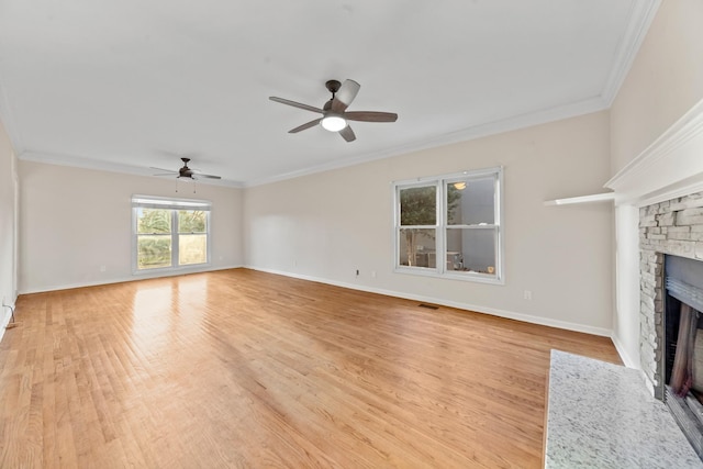 unfurnished living room featuring a fireplace, ornamental molding, and light wood-type flooring