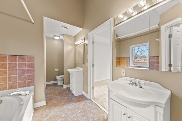 bathroom with vanity, a washtub, tile patterned floors, and toilet