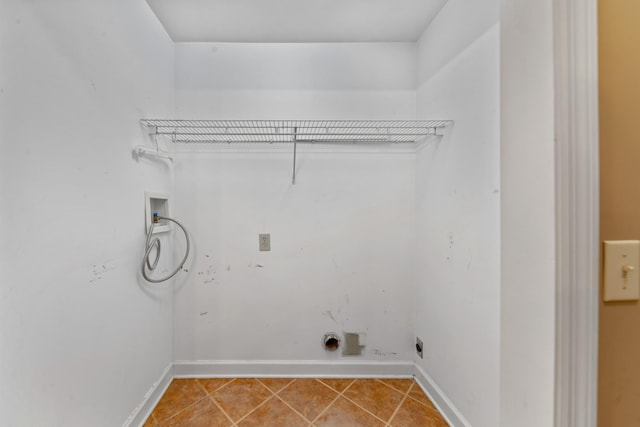 laundry room with electric dryer hookup, washer hookup, and tile patterned floors