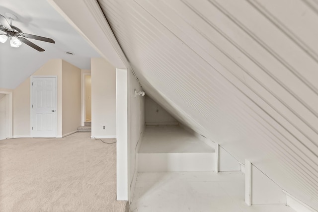 additional living space featuring vaulted ceiling, light colored carpet, and ceiling fan