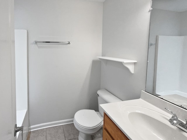 bathroom featuring vanity, a washtub, and toilet