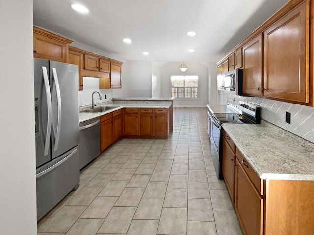 kitchen featuring sink, light tile patterned floors, stainless steel appliances, decorative backsplash, and kitchen peninsula