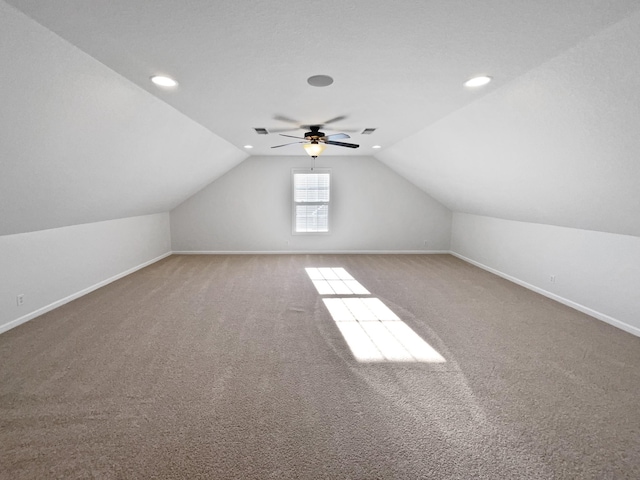 bonus room featuring lofted ceiling, carpet, and ceiling fan