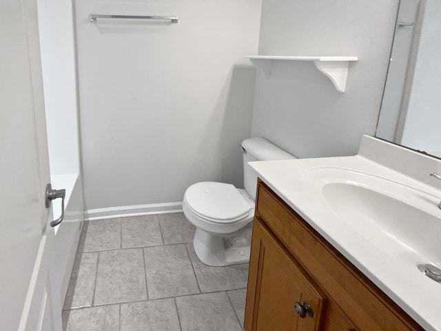 bathroom with vanity, a bathing tub, and toilet