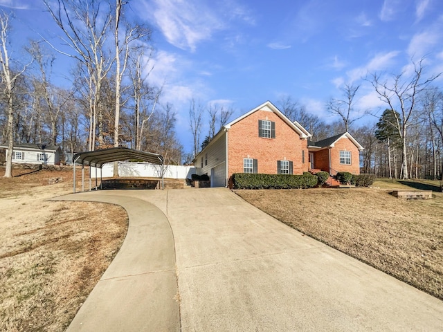 view of side of home with a carport and a yard