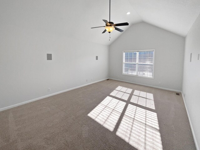 carpeted spare room featuring high vaulted ceiling and ceiling fan