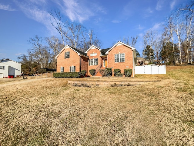 view of front facade with a front yard and a carport