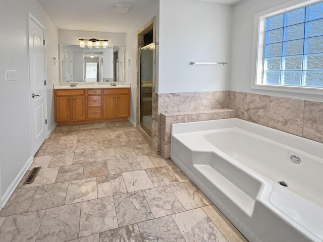 bathroom featuring vanity and shower with separate bathtub