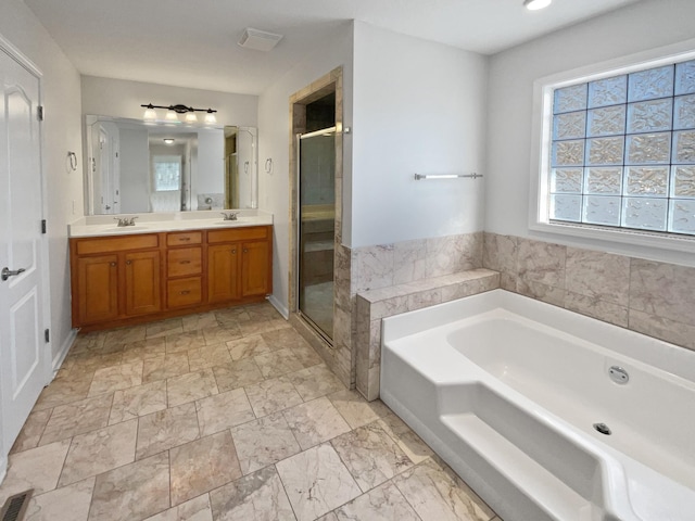 bathroom featuring vanity and shower with separate bathtub