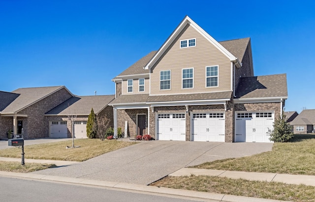 view of front of property featuring a garage and a front lawn