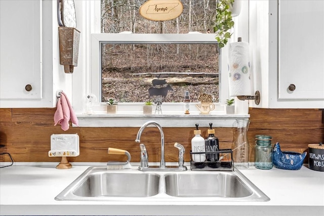 kitchen with white cabinetry and sink