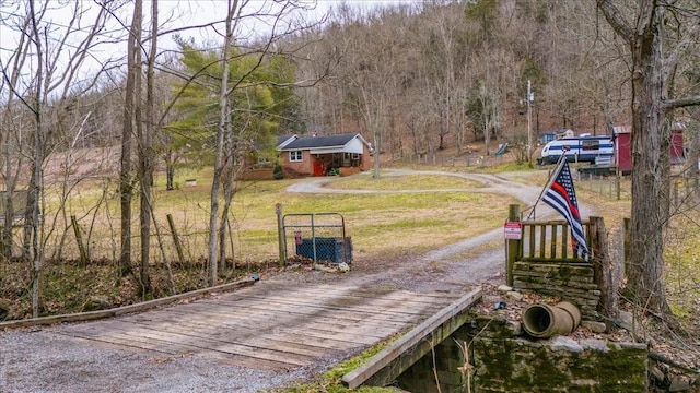 view of community featuring a yard and an outbuilding