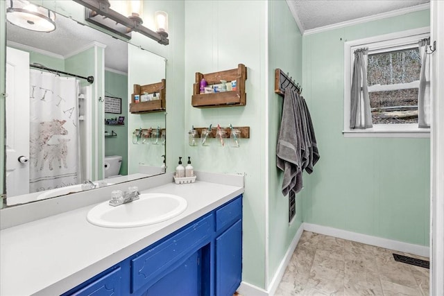 bathroom featuring ornamental molding, vanity, a textured ceiling, and toilet