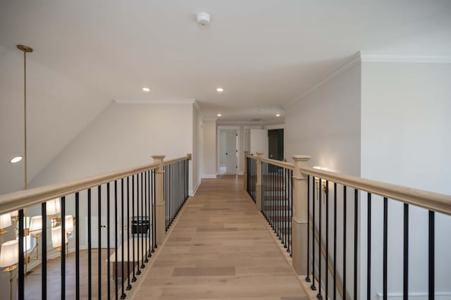 hall with crown molding and light hardwood / wood-style flooring