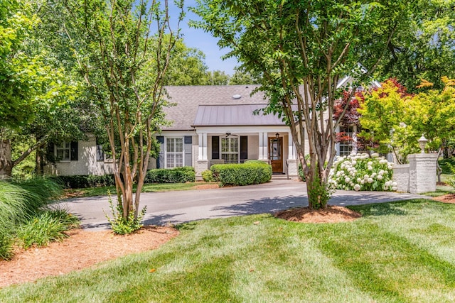 view of front of home featuring covered porch and a front lawn