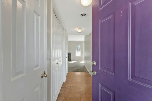 hallway featuring parquet flooring