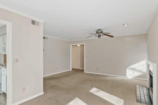 unfurnished room featuring crown molding, light colored carpet, and ceiling fan