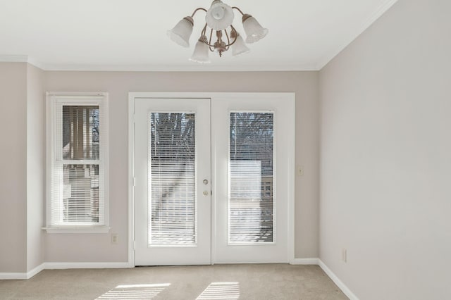 entryway with crown molding, light carpet, and french doors