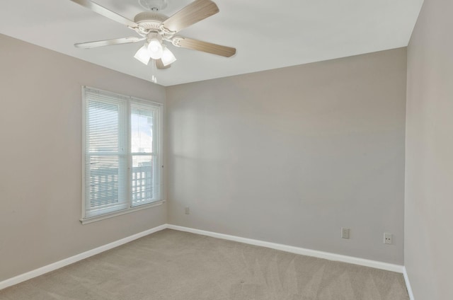 spare room featuring light carpet and ceiling fan