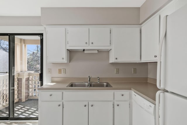 kitchen with white cabinetry, sink, and white appliances