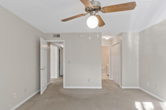 spare room with light carpet and ceiling fan