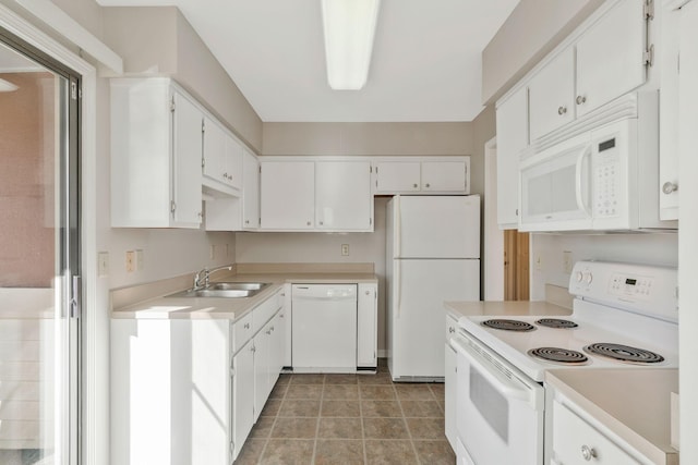 kitchen featuring tile patterned floors, sink, white cabinets, and white appliances