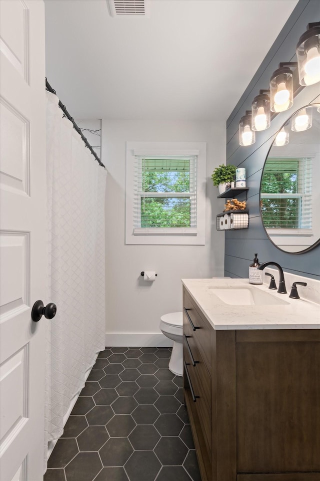 bathroom with vanity, tile patterned floors, and toilet