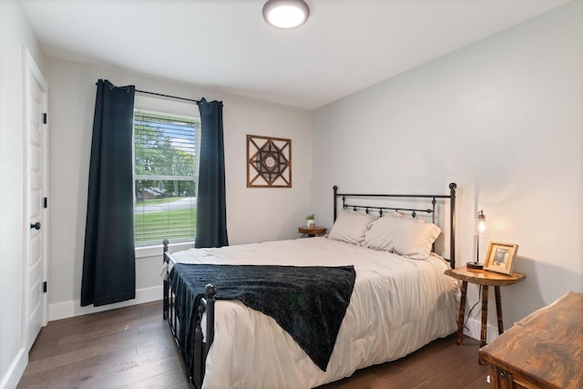 bedroom with dark wood-type flooring