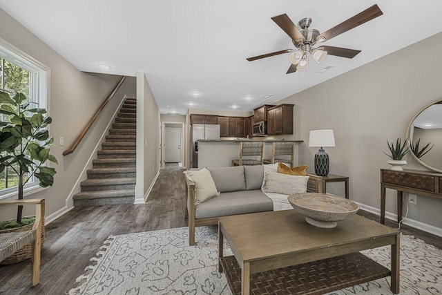 living room with dark wood-type flooring and ceiling fan