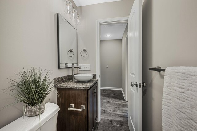 bathroom featuring vanity, hardwood / wood-style floors, and toilet