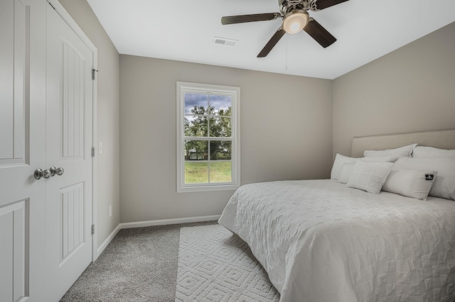 bedroom featuring light carpet and ceiling fan