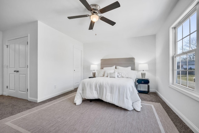 bedroom featuring multiple windows, carpet flooring, and ceiling fan