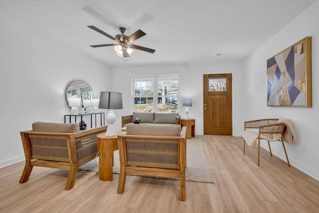 living room featuring light hardwood / wood-style flooring and ceiling fan