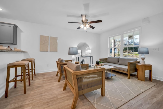 living room with ceiling fan and light hardwood / wood-style floors