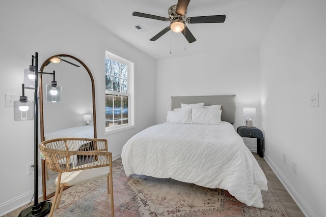 bedroom with hardwood / wood-style flooring and ceiling fan