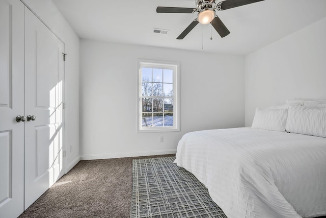 bedroom featuring ceiling fan and dark carpet