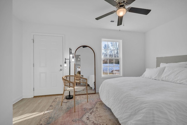 bedroom with ceiling fan and light hardwood / wood-style flooring