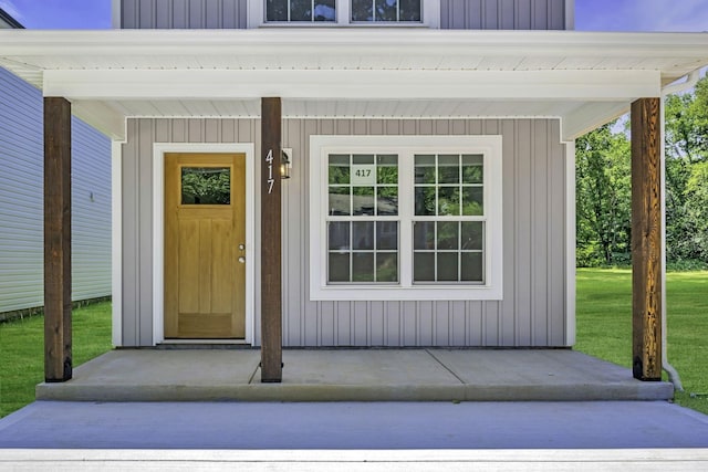 view of exterior entry featuring a yard