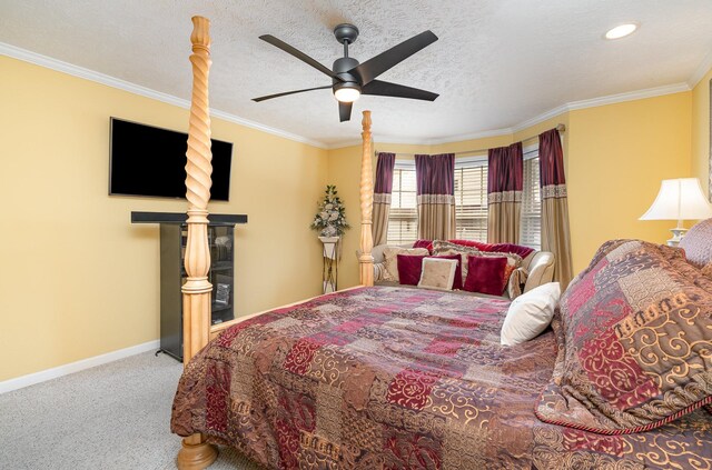 carpeted bedroom featuring ceiling fan, ornamental molding, and a textured ceiling